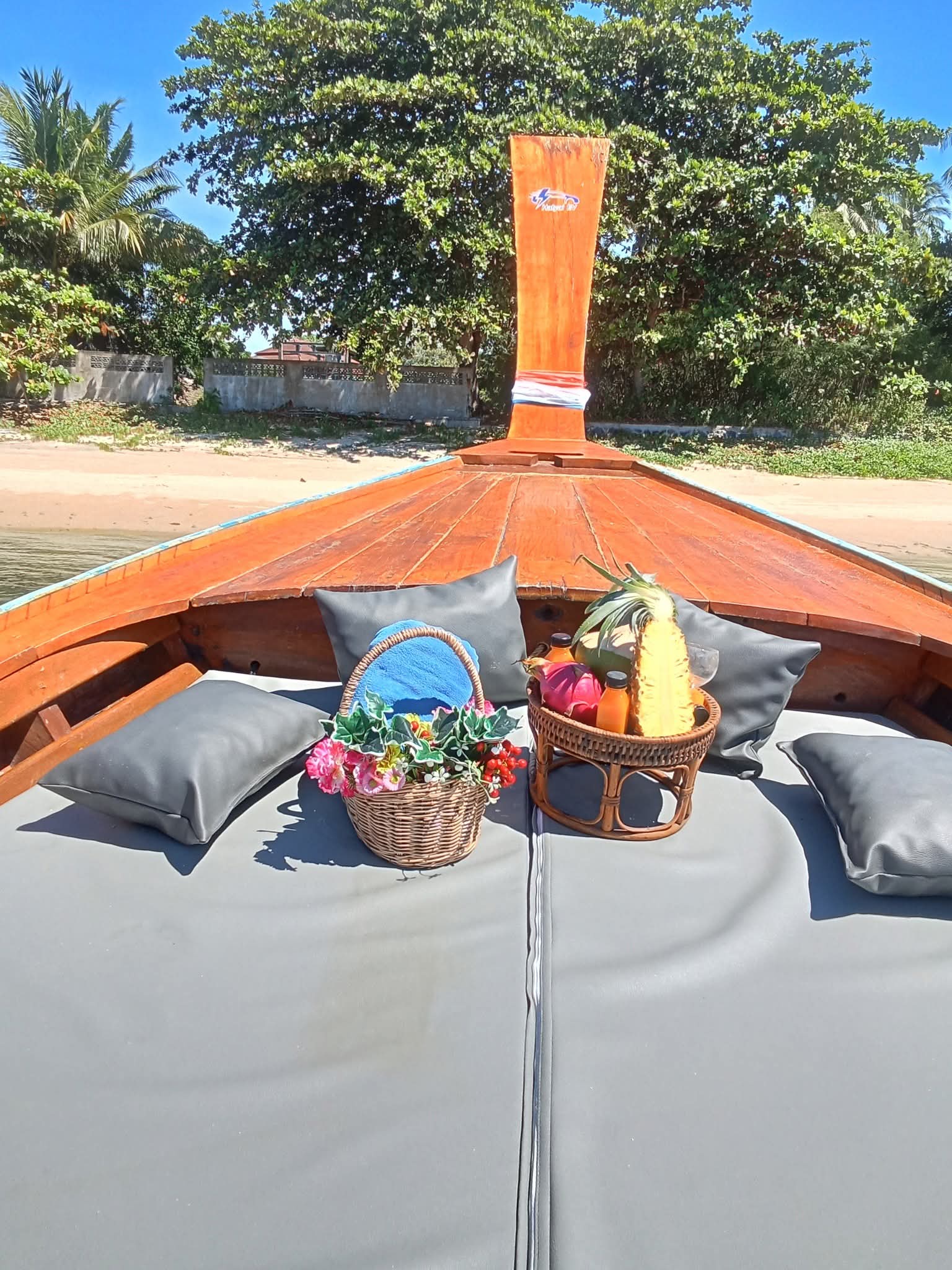 Welcome basket with fresh fruit and flowers on the boat's bow seating